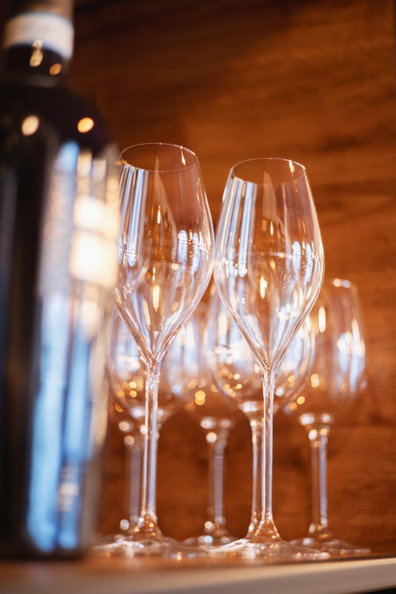 A row of empty wine glasses catching the warm light